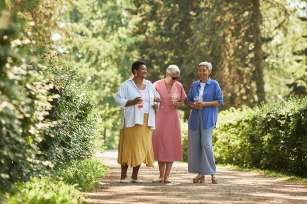 Three women enjoying a walk outdoors, representing better blood pressure and longevity